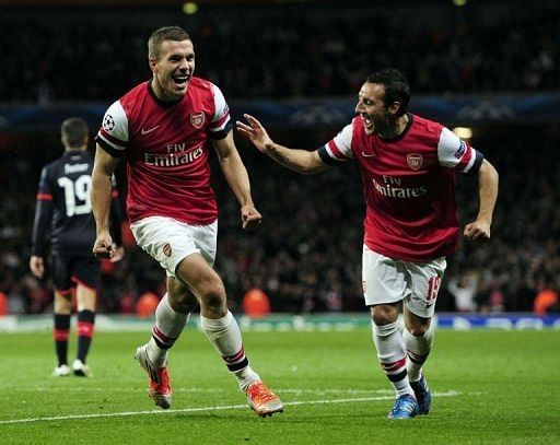 Arsenal's Santi Cazorla (R) runs to congratulate Lukas Podolski (L)